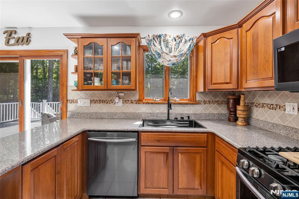 21 Marcia Road Ringwood, NJ 07456 - Photo 13 of 42 a kitchen with stainless steel appliances granite countertop a sink stove and cabinets