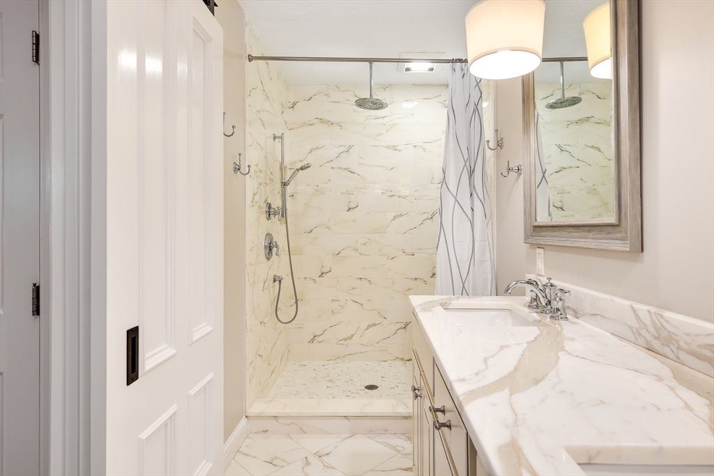 22 Forest Lane, Unit 22 Scituate, MA 02066 - Photo 16 of 27 a bathroom with a shower and a sink