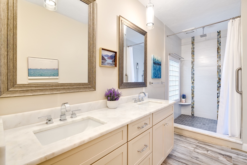 22 Forest Lane, Unit 22 Scituate, MA 02066 - Photo 17 of 27 a bathroom with a double vanity sink mirror and double