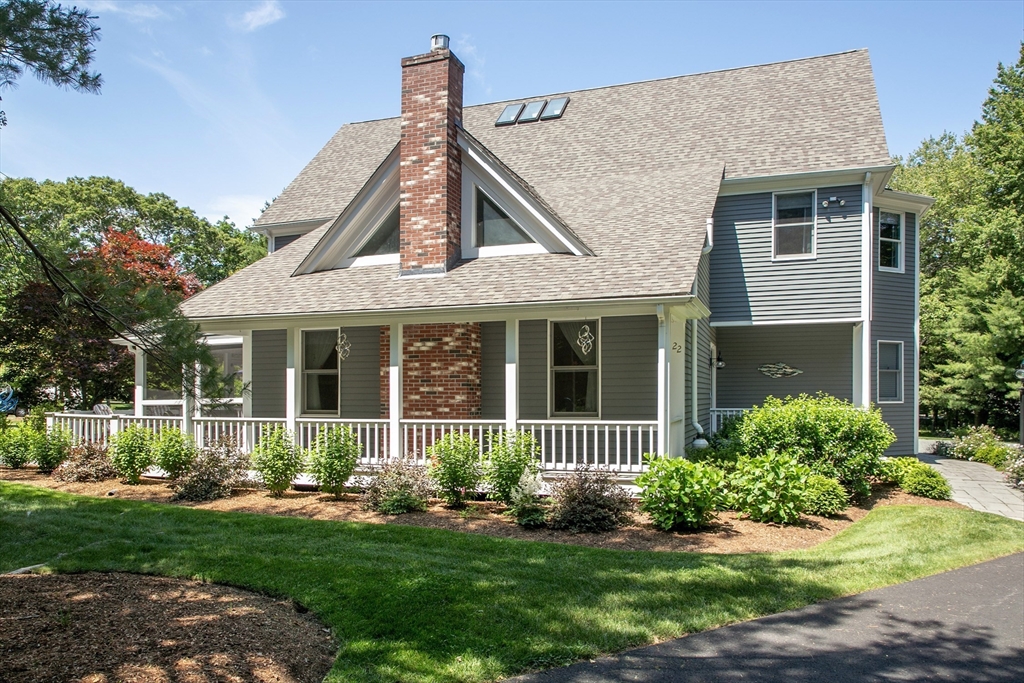 22 Forest Lane, Unit 22 Scituate, MA 02066 - Photo 27 of 27 a front view of a house with a garden and plants