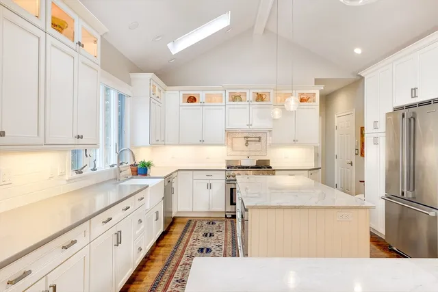a kitchen with a stove a sink and a refrigerator