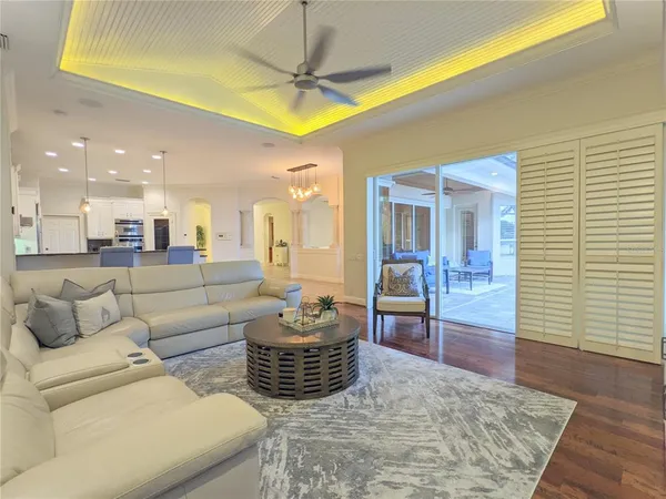 a kitchen with kitchen island granite countertop a stove a sink a oven a dining table and chairs