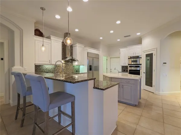 a large kitchen with a sink and cabinets
