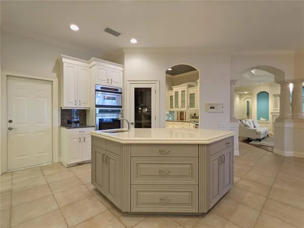 a kitchen with granite countertop white cabinets and sink