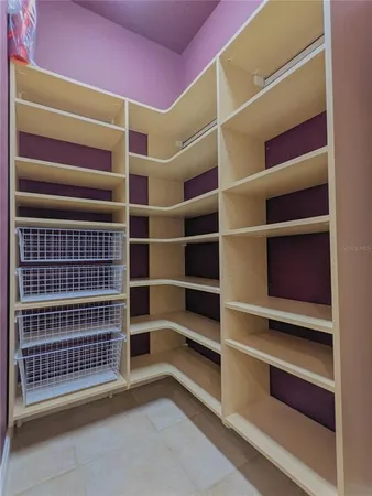 a kitchen with white cabinets and sink