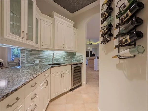 a spacious bedroom with a bed and a chandelier