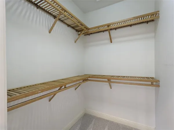 a bathroom with a toilet a sink a mirror and a shower