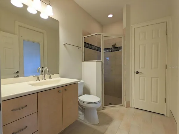 a bathroom with a granite countertop toilet sink and a mirror