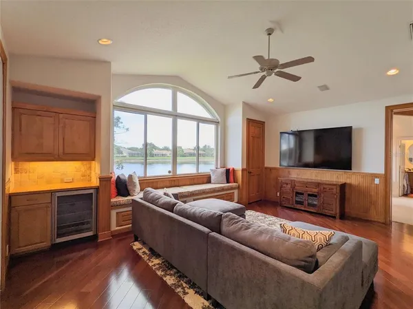 a living room with furniture a flat screen tv and a fireplace