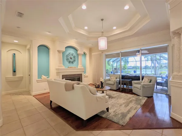 a living room with furniture a ceiling fan and a rug