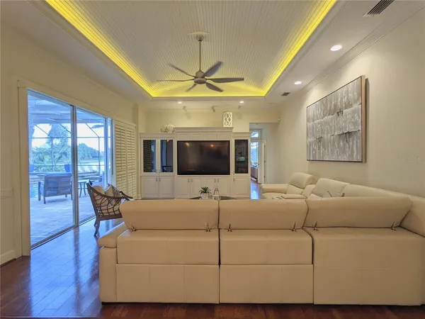a living room with furniture and a chandelier