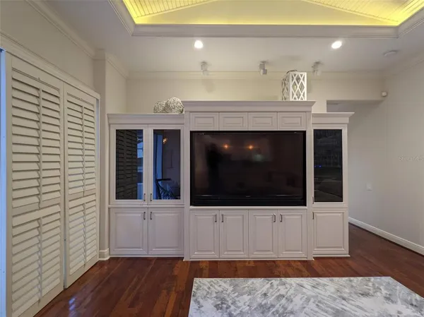 a living room with furniture a dining table and a potted plant