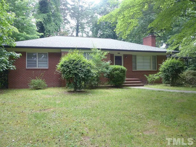 a view of a house with garden and plants