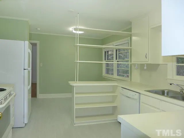 a bathroom with a sink shower and a mirror