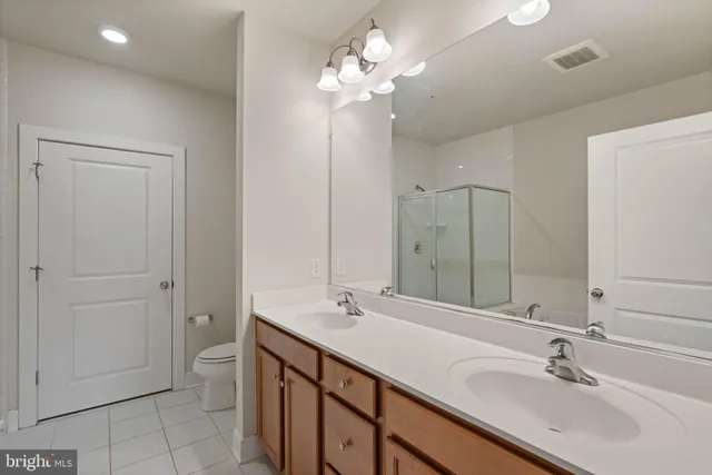 a bathroom with a double vanity sink a and a mirror
