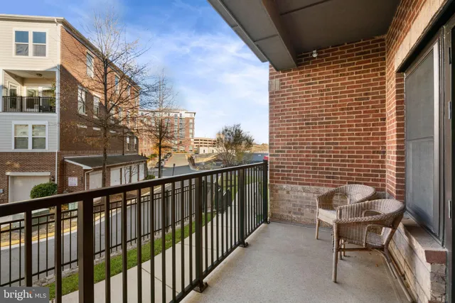 a view of a balcony with chair and iron fence