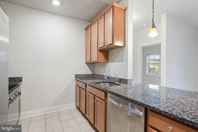 a kitchen with stainless steel appliances granite countertop a sink and a stove