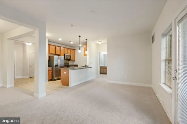 a view of kitchen with kitchen island and stainless steel appliances