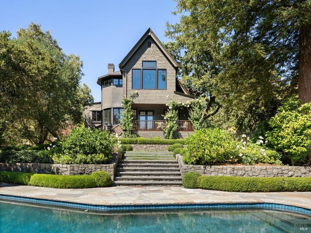 a front view of a house with a yard table and chairs