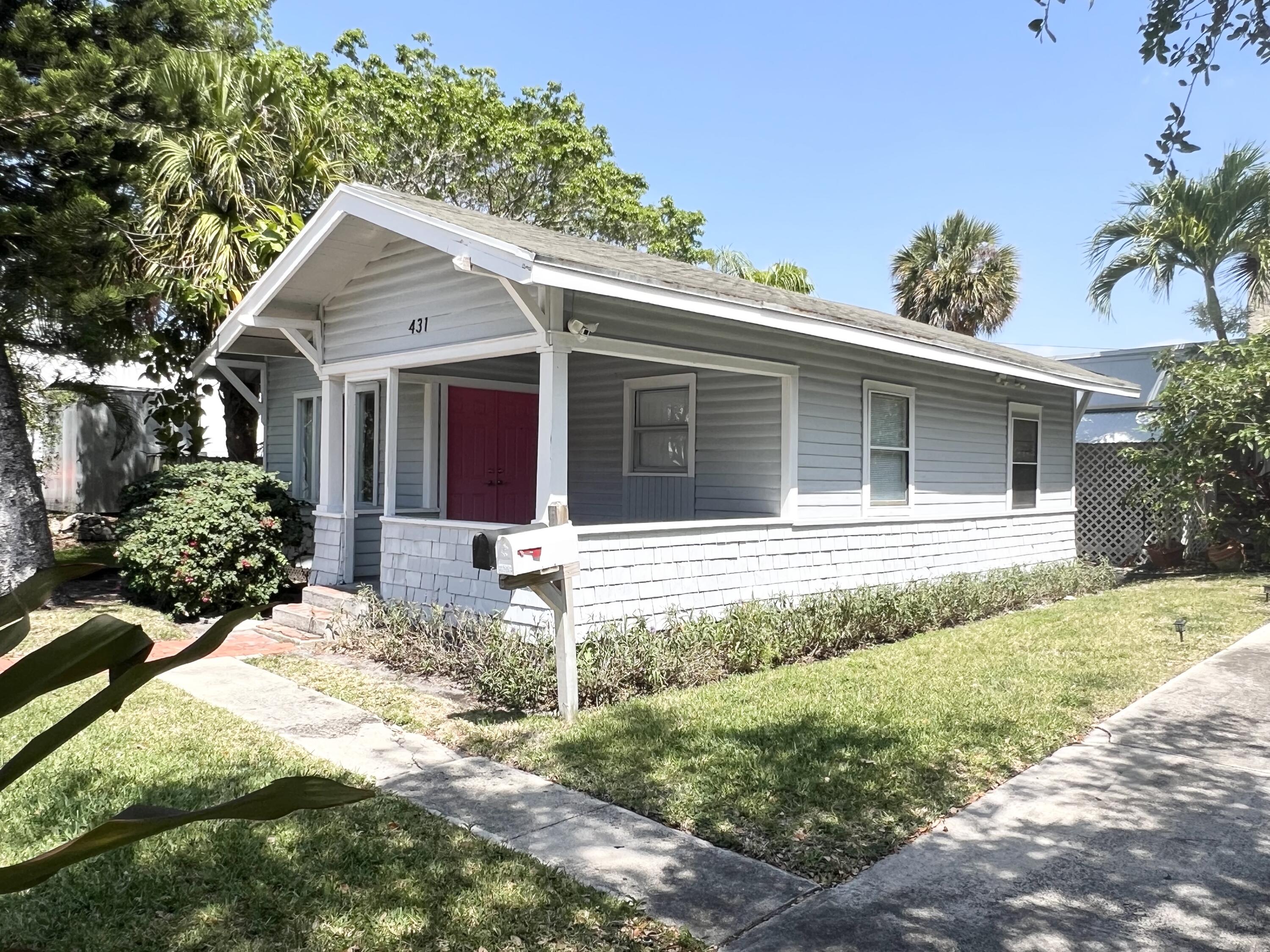 431 Ardmore Road West Palm Beach, FL 33401 - Photo 2 of 13 a front view of a house with a yard and potted plants