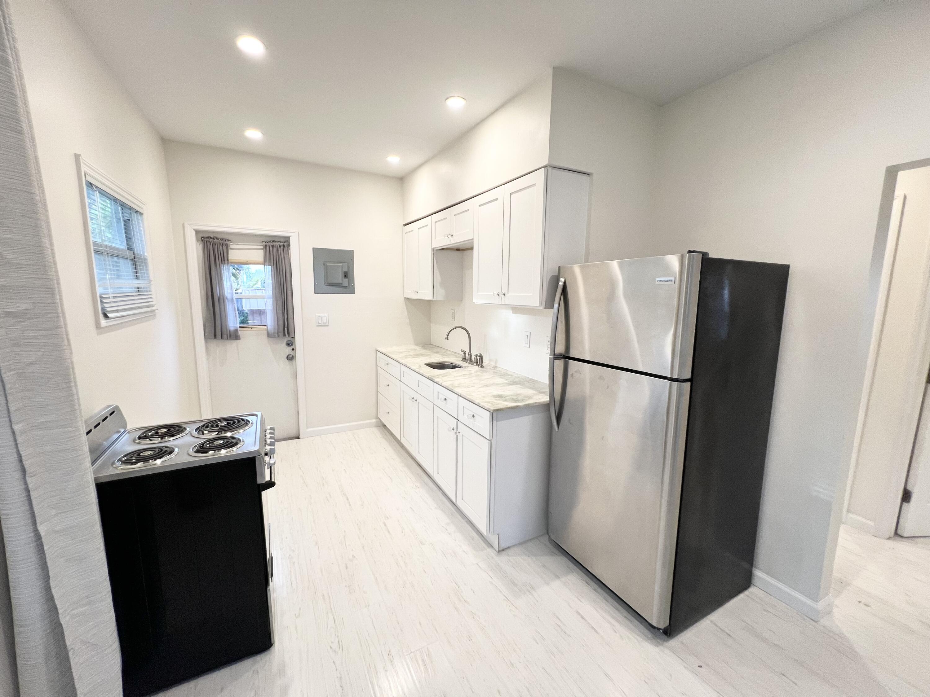 431 Ardmore Road West Palm Beach, FL 33401 - Photo 3 of 13 a kitchen with stainless steel appliances granite countertop a refrigerator a stove a sink and a refrigerator