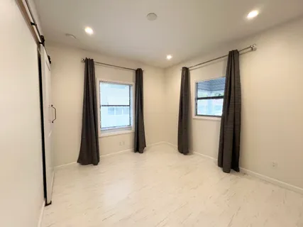 a big room with closet and mirror