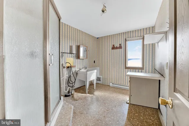 a kitchen with stainless steel appliances granite countertop a sink refrigerator and cabinets