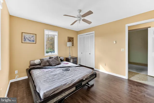 a kitchen with stainless steel appliances granite countertop a refrigerator a sink dishwasher a stove and a microwave oven with white cabinets