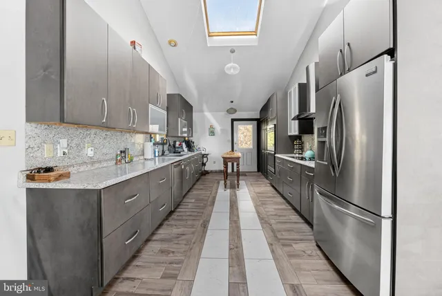 a bathroom with a sink a tub and shower