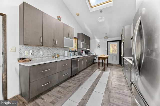 a spacious bathroom with a granite countertop tub sink and mirror