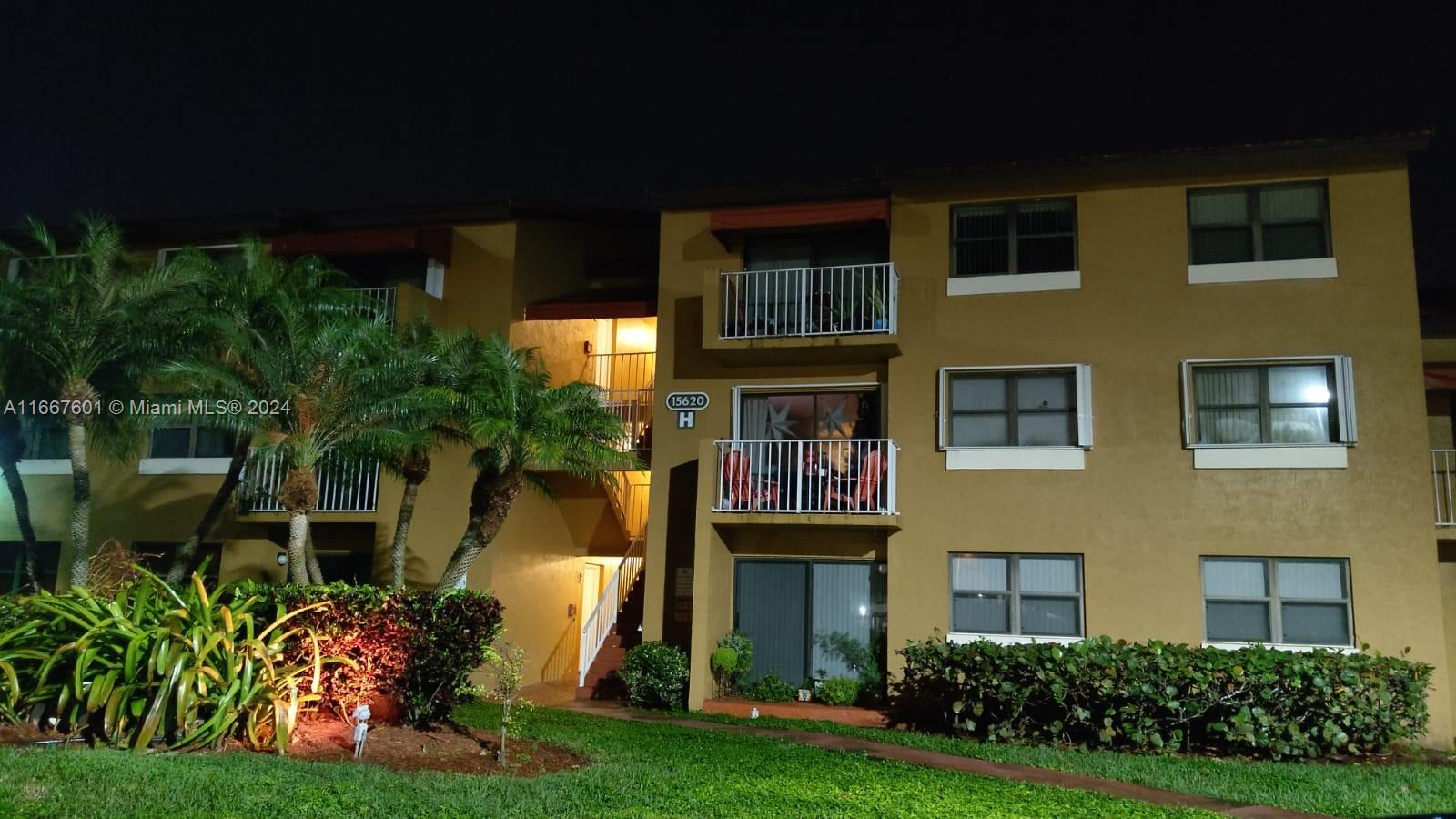 15620 Southwest 80th Street, Unit H107 Miami, FL 33193 - Photo 1 of 7 a front view of a house with a yard