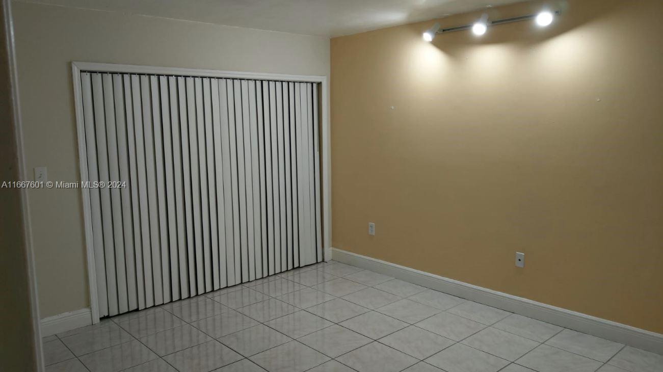 15620 Southwest 80th Street, Unit H107 Miami, FL 33193 - Photo 3 of 7 a view of a room with wooden floor