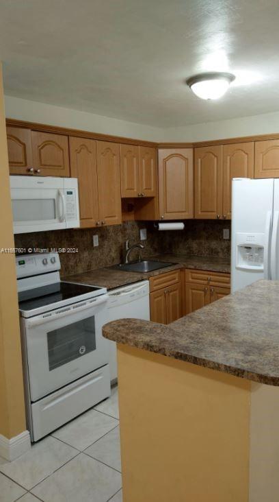 15620 Southwest 80th Street, Unit H107 Miami, FL 33193 - Photo 5 of 7 a kitchen with granite countertop a sink a stove and cabinets