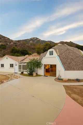 an aerial view of residential houses with a yard