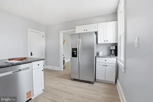 a kitchen with stainless steel appliances a refrigerator sink and stove