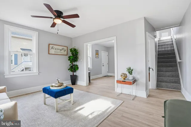 a living room with furniture and a potted plant