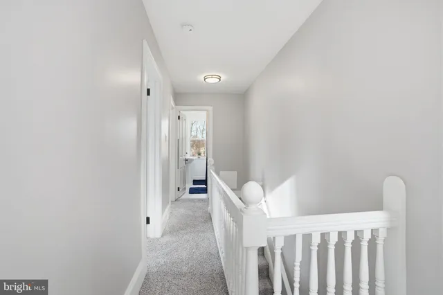 a view of a kitchen with wooden floor and a refrigerator