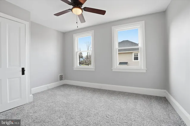 a bedroom with a bed and a potted plant