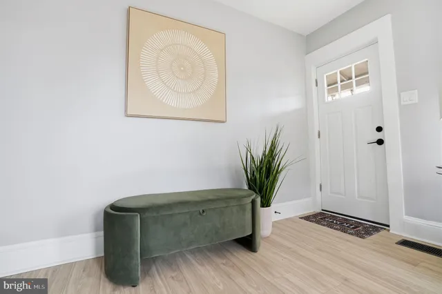 a view of room with wooden floor and potted plant