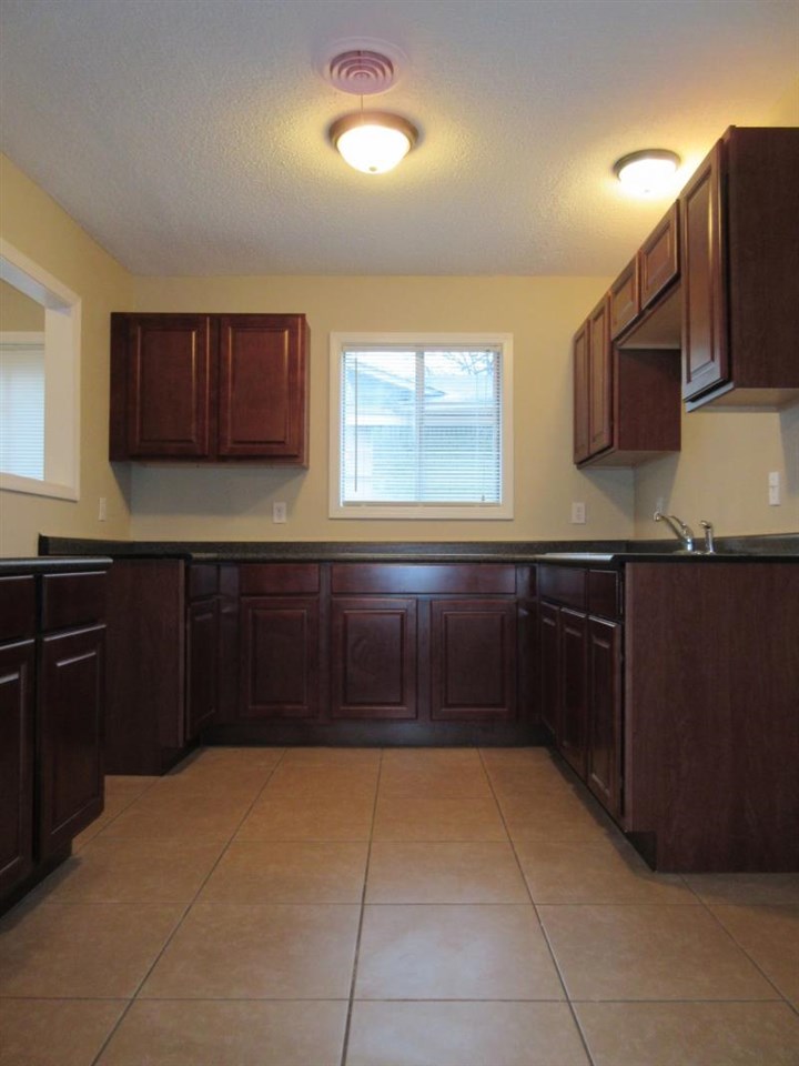 4324 Sidney Road Memphis, TN 38116 - Photo 3 of 8 a kitchen with a sink and cabinets