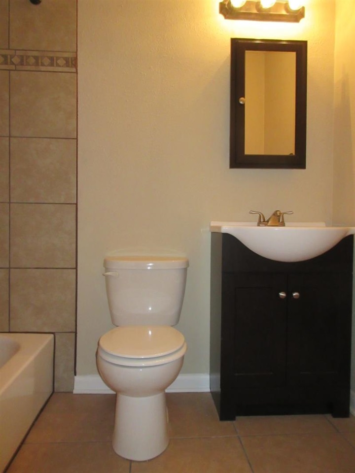 4324 Sidney Road Memphis, TN 38116 - Photo 4 of 8 a bathroom with a toilet sink and mirror