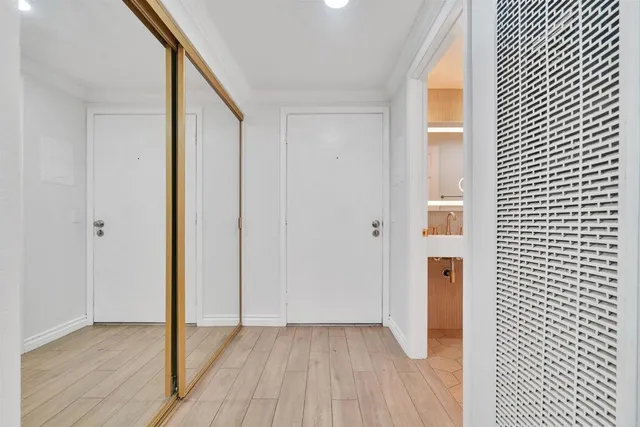 a view of a hallway with wooden floor