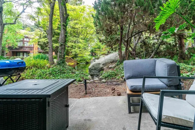 a backyard of a house with table and chairs