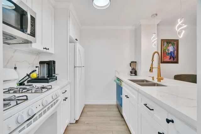 a kitchen with a sink stove and refrigerator