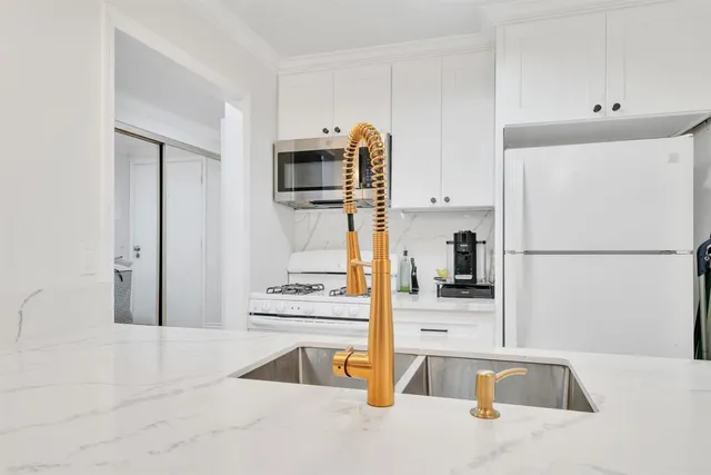 a kitchen with a refrigerator and a sink