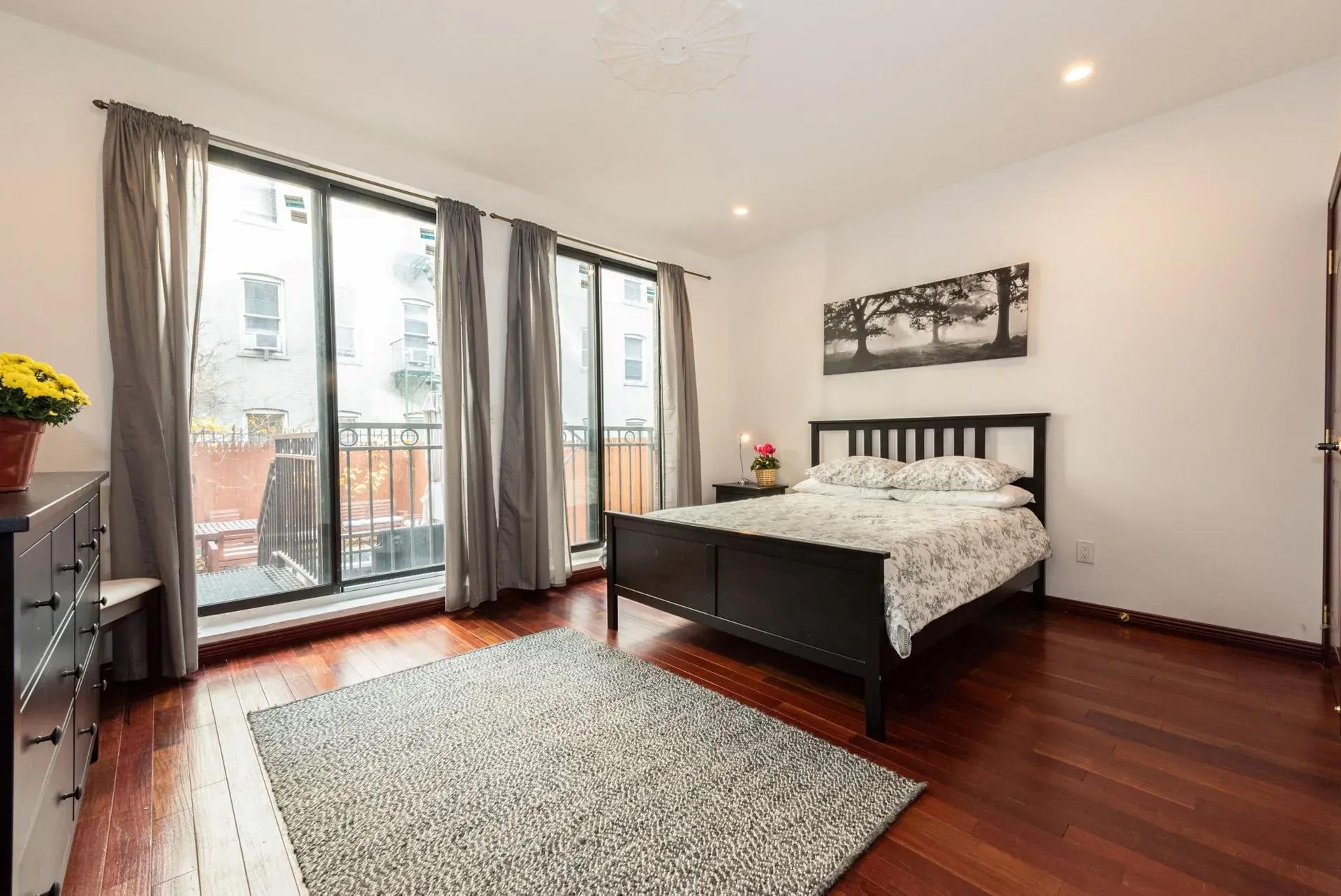475 West 146th Street Manhattan, NY 10031 - Photo 12 of 19 a bedroom with a bed painting and wooden floor