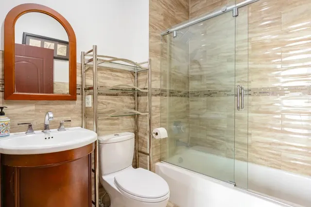 a bathroom with a sink toilet and shower