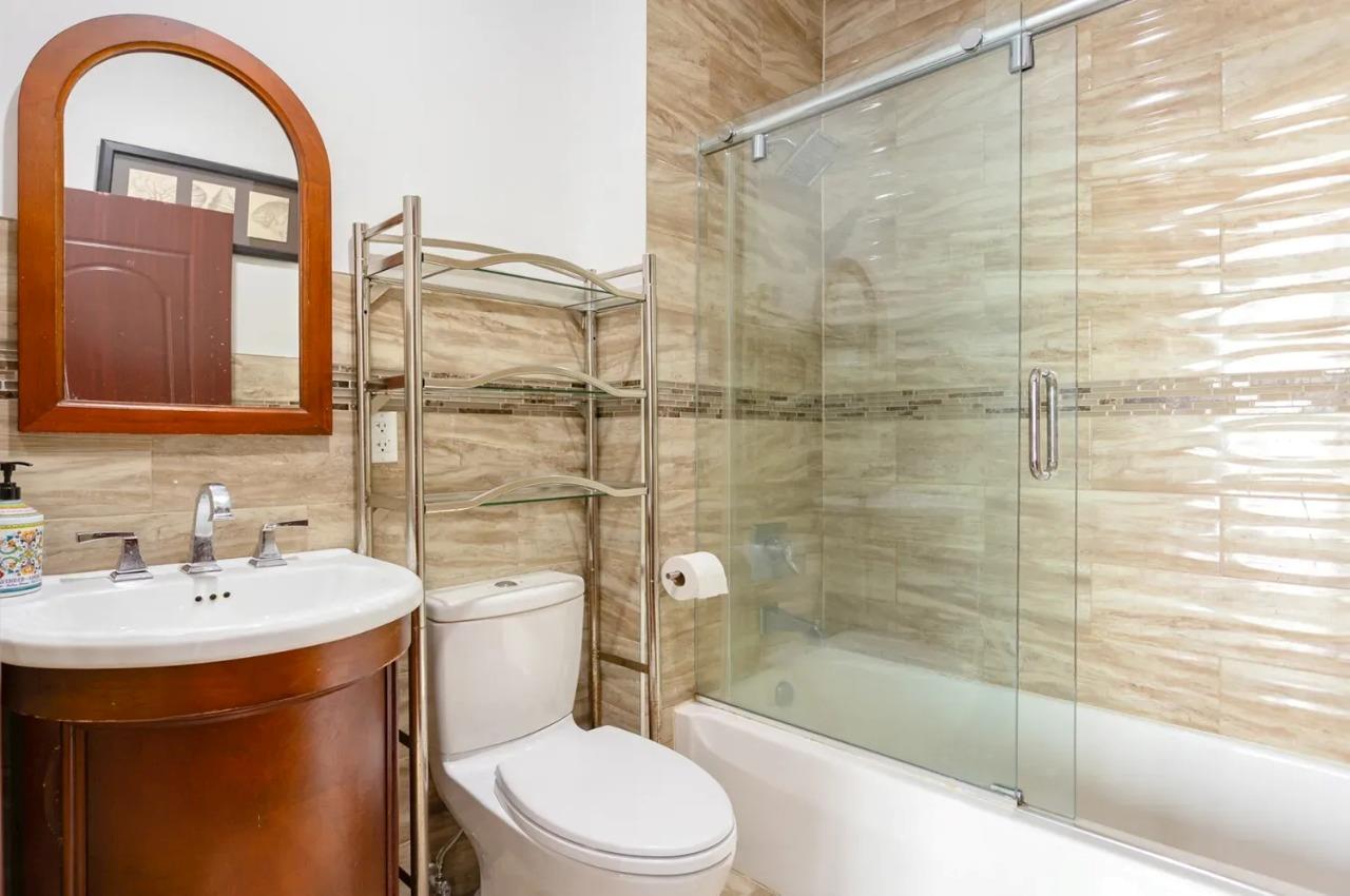 475 West 146th Street Manhattan, NY 10031 - Photo 15 of 19 a bathroom with a sink toilet and shower