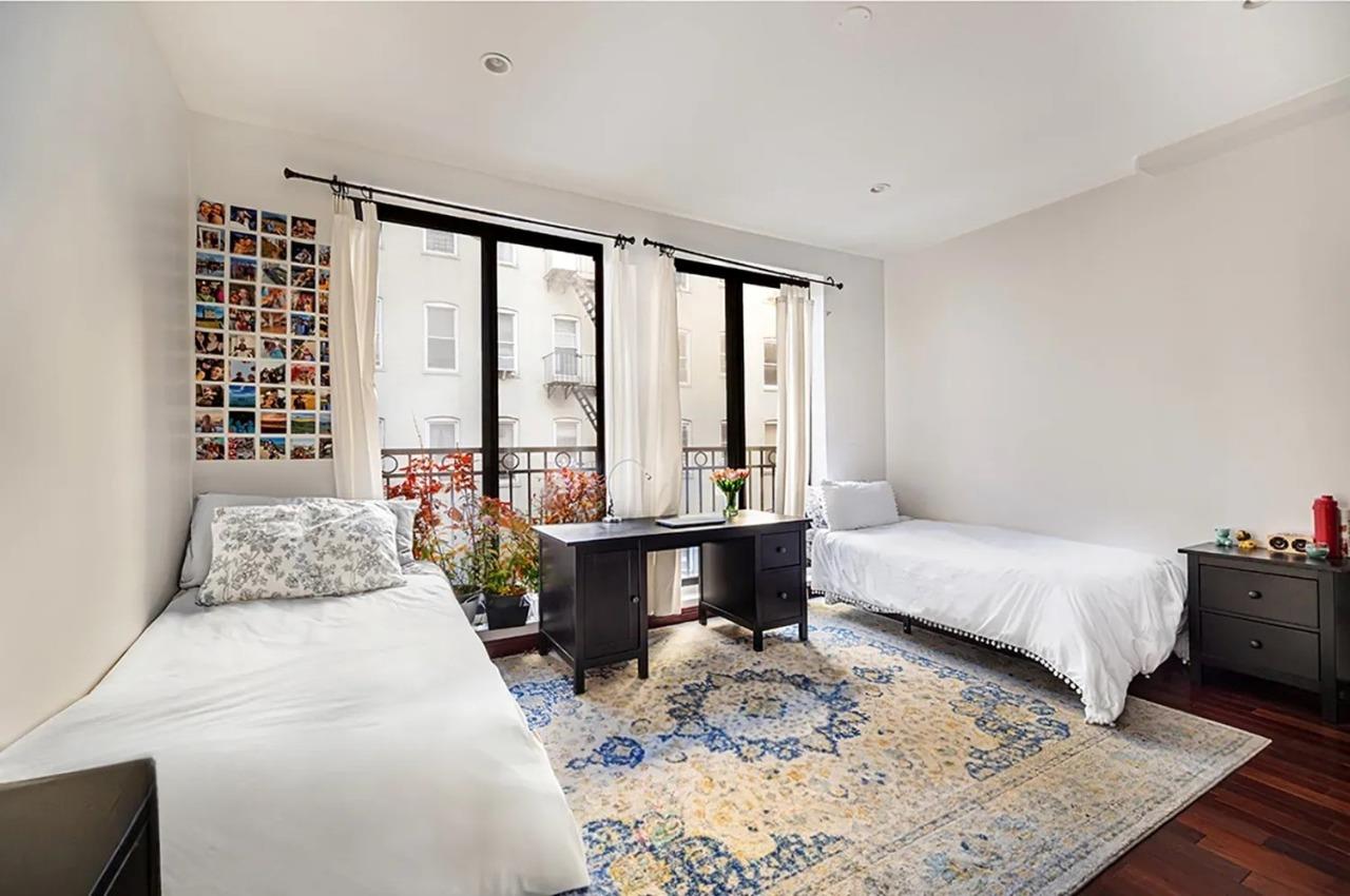 475 West 146th Street Manhattan, NY 10031 - Photo 16 of 19 a bedroom with a large bed and a window