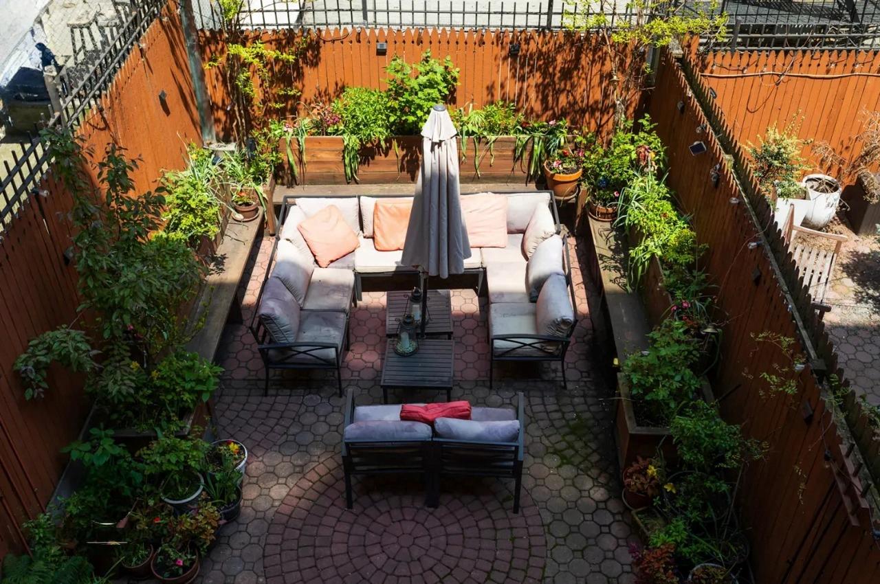 475 West 146th Street Manhattan, NY 10031 - Photo 18 of 19 a backyard of a house with lots of green space and fountain